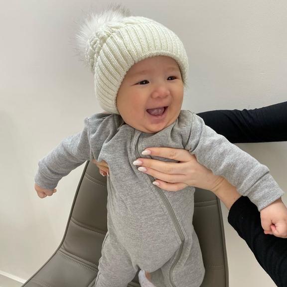 Filho de Pyong surge em momento encantador ao se agasalhar sorridente para se proteger do frio